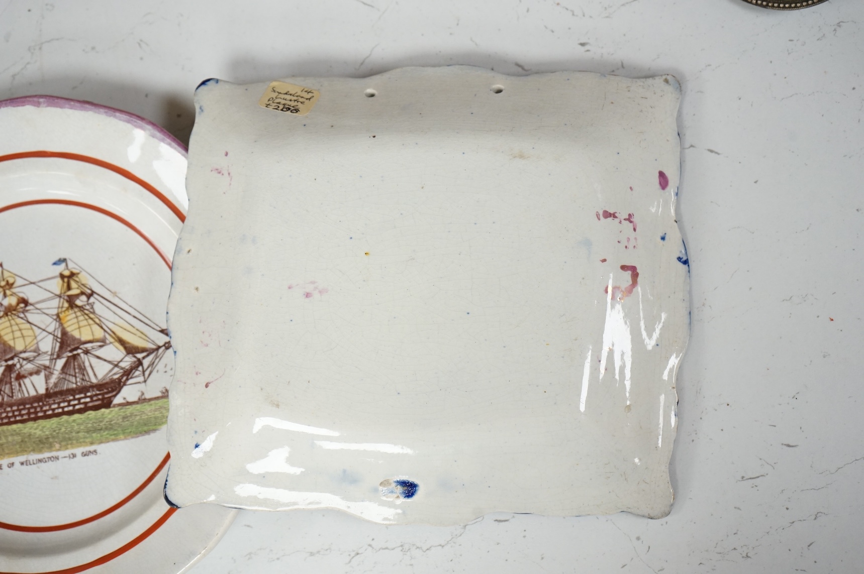 A 19th century Sunderland pink lustre ‘ship’ plaque and an HMS, Duke of Wellington plate, largest 24cm in diameter